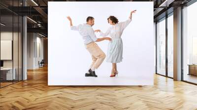 Portrait of young beautiful couple, man and woman, dancing isolated over white studio background. Ecstatic dance Wall mural