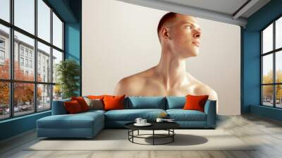 Portrait of young red-haired freckled man posing shirtless isolated over grey studio background. Wall mural