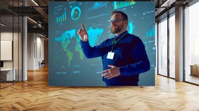 Speaker, lecturer stands near presentation board with graphs, maps and pointing up drawing audience's attention to important details in his speech. Concept of business, startup, personal development. Wall mural