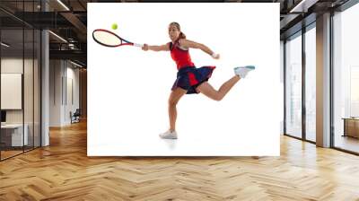 Studio shot of active teen girl, professional tennis player training with tennis racket over white background. Sport, fashion, ad, action, motion, achievement concept Wall mural