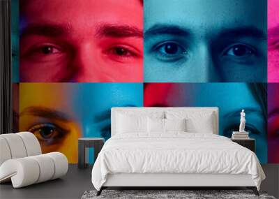 Unlike the others. Close-up. Cropped male and female faces, eyes looking at camera over colorful neon lights. Concept of human emotions, facial expressions Wall mural