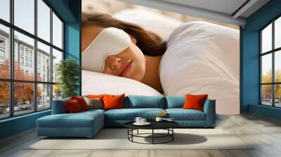 A young woman wearing a sleep mask, sleeping comfortably in a bed, symbolizes peaceful sleep, relaxation and rest, a replica of space. The concept of a peaceful sound sleep. . Wall mural