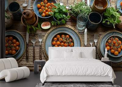 A top-down view of a boho kitchen table set for a meal, showcasing a mix of patterned plates and rustic cutlery on a hand-woven tablecloth. Wall mural