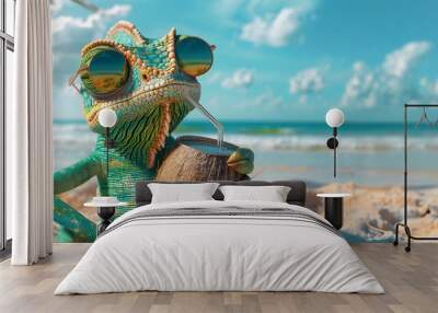 A chameleon wearing sunglasses sits on a beach drinking from a coconut. Wall mural