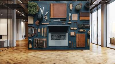 Flat lay of various tools and leather goods on a blue background. Wall mural