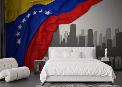 abstract silhouette of the city with text Barquisimeto near waving colorful national flag of venezuela on a gray background. Wall mural