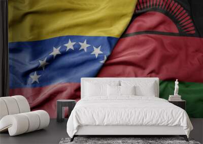 big waving national colorful flag of malawi and national flag of venezuela . macro Wall mural