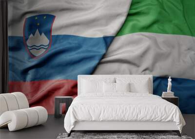 big waving national colorful flag of sierra leone and national flag of slovenia. Wall mural