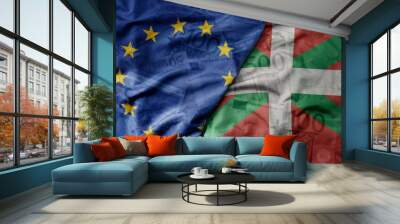 big waving realistic national colorful flag of european union and national flag of basque country on a euro money banknotes background. Wall mural