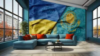 big waving realistic national colorful flag of kazakhstan and national flag of ukraine on a euro money banknotes background. Wall mural