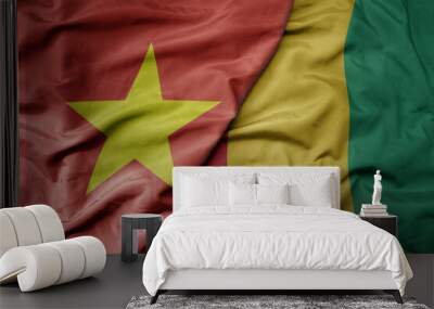 big waving realistic national colorful flag of vietnam and national flag of guinea . Wall mural