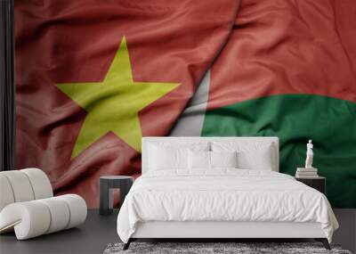 big waving realistic national colorful flag of vietnam and national flag of madagascar . Wall mural