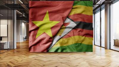 big waving realistic national colorful flag of vietnam and national flag of zimbabwe . Wall mural