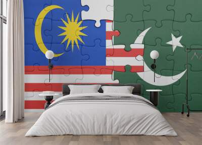 puzzle with the colourful national flag of pakistan and flag of malaysia. Wall mural