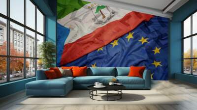 waving colorful flag of european union and flag of equatorial guinea on a euro money banknotes background. finance concept. Wall mural