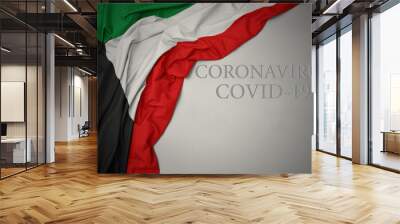 waving national flag of kuwait on a gray background with text coronavirus covid-19 . concept. Wall mural