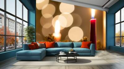 Christmas advent candle with lights in background Wall mural