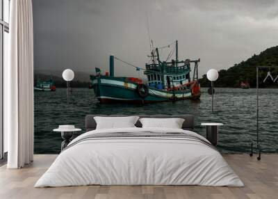 Fishing boat in stormy sea  Wall mural