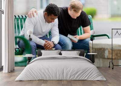 Two men praying on a bench Wall mural