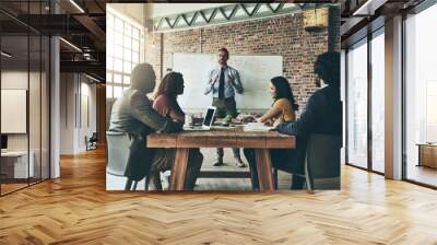 Every day holds an opportunity for success. Shot of a well-dressed businessman giving a presentation to his colleagues in the office. Wall mural