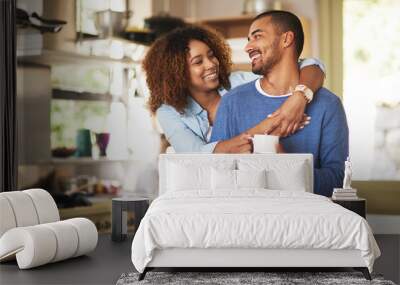 Honey, youre the best. Shot of a happy young couple feeling relaxed in the at home. Wall mural