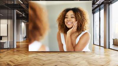 Getting ready in the morning is never a struggle. Shot of an attractive young woman admiring herself in the bathroom mirror. Wall mural