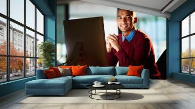 I have no trouble working late. Portrait of a handsome young man working late in his office. Wall mural