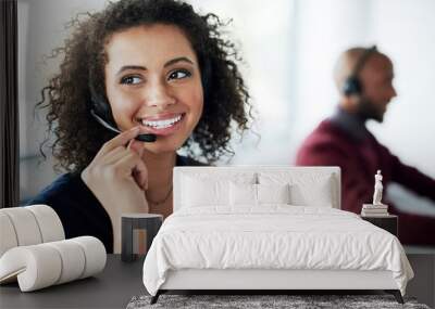 That sounds like something we can help you with. Cropped shot of an attractive young female call center agent looking thoughtful while working in her office. Wall mural