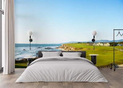 Golf course putting green and cliffs by the pacific ocean bay.  Halfmoon Bay California.  Villas and houses. Wall mural