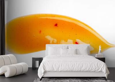 Dripping orange sauce isolated on white background. Abstract pattern made of chilli sauce. Flat lay, top view, close up. Wall mural