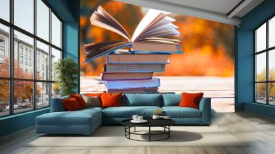 Open book on wooden table on natural background. Soft focus Wall mural