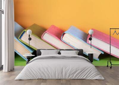 Set of colored books on bright colorful background. Back to school Wall mural