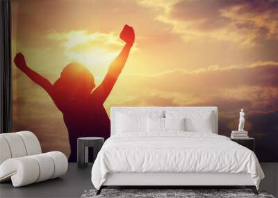 cheering woman open arms at sunrise seaside Wall mural