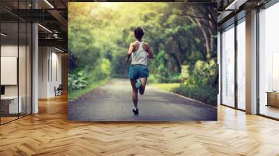 Female runner running at summer park trail . Healthy fitness woman jogging outdoors. Wall mural