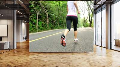 fitness woman running at forest road  Wall mural