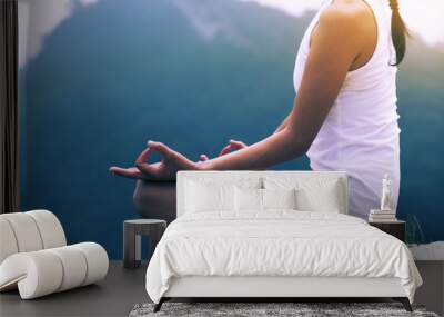 One fitness woman practicing yoga at mountain peak Wall mural