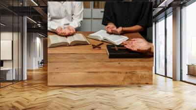 A person reads the Bible, embodying faith and spirituality. The scene reflects a serene moment of contemplation and devotion, highlighting the importance of religion in everyday life. Wall mural