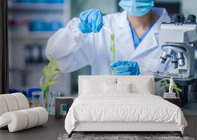 Female science biology laboratory worker using pipette, test tubes, microscope in sustainability plants research to experiment with the development of anti-aging medicine and vitamins Wall mural