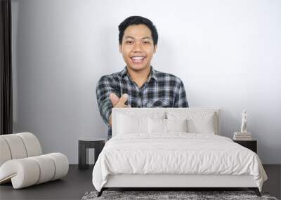 positive asian man showing korean love symbol with happy smile isolated Wall mural