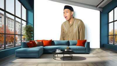 thoughtful asian muslim man wearing koko clothes confused isolated on white background Wall mural