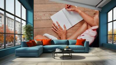 Notebook, writing and planning woman with journal for ideas, inspiration and creativity on wood floor above. Creative young person with mindfulness, healing notes and self care book for writer goals Wall mural