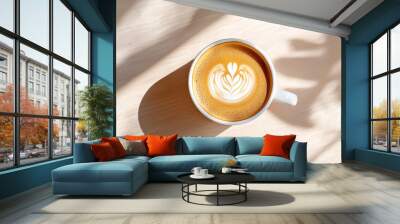 Close-up view of a beautifully crafted latte art heart design on a cappuccino in a white ceramic cup on a wooden table Wall mural