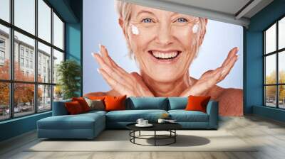 Beauty, portrait of mature woman and cream for skincare, anti aging and wellness on a grey studio background. Skin care, moisturiser or lotion with a senior female apply suncream or spf on her face Wall mural