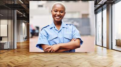 Portrait, black woman and security guard smile with arms crossed in surveillance service, safety and city patrol. Law enforcement, proud bodyguard or happy female police officer in blue shirt outdoor Wall mural