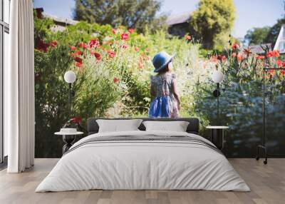 toddler girl playing in  summer   garden Wall mural