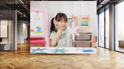 young girl making snow flakes craft for homeschooling Wall mural