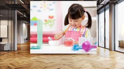 young  girl making sweet gems for homeschooling Wall mural