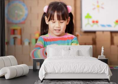 young girl playing creative toy blocks at home Wall mural