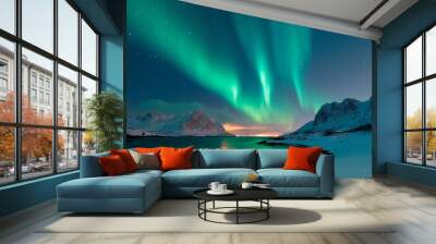 Beautiful Northern Lights lighting up the night sky over snow-capped mountains and a serene lake. Wall mural