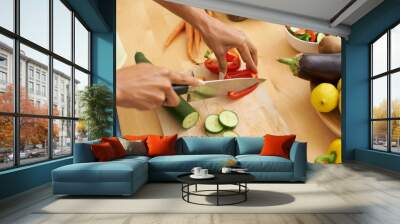 Closeup, hands and cutting with vegetables, nutrition and plant based diet in a kitchen. Person, home and cooking health food, lunch and vegan meal with variety, vitality and weight loss with knife Wall mural